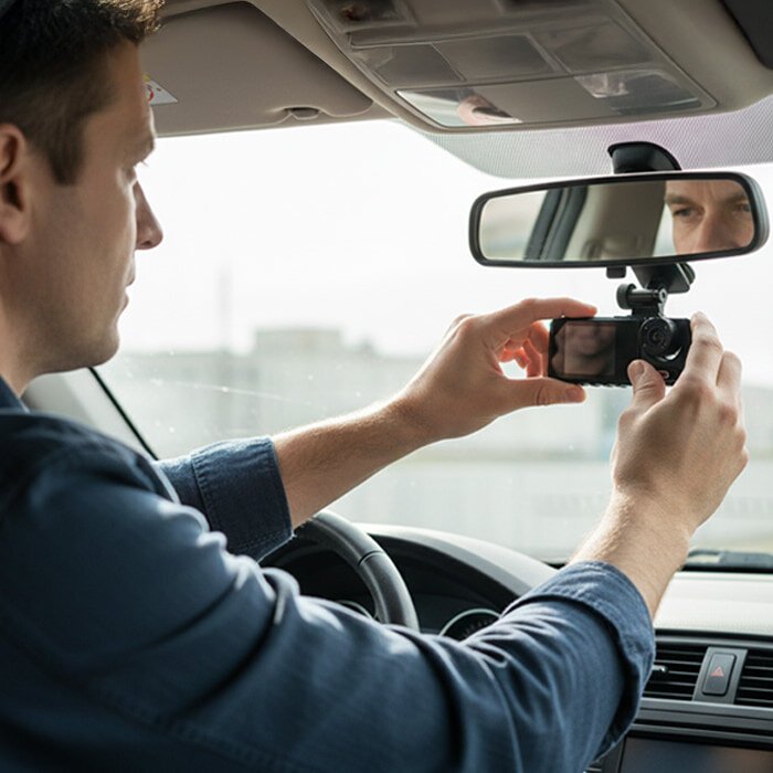 Mounting a compact dash camera behind the windshield